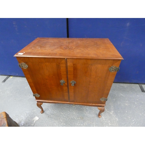 420 - Mahogany two-door cabinet with ornate hinges, on cabriole supports.