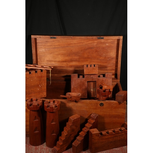 124 - Wooden castle building set within mahogany blanket box.