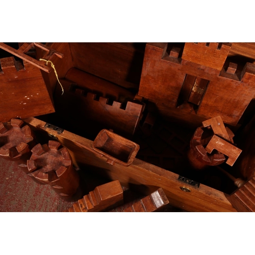 124 - Wooden castle building set within mahogany blanket box.