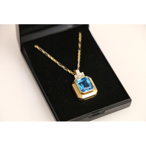 133 - 14ct gold pendant set with a vibrant blue rectangle cut stone, on 14ct gold chain 23cm, 11.4g.