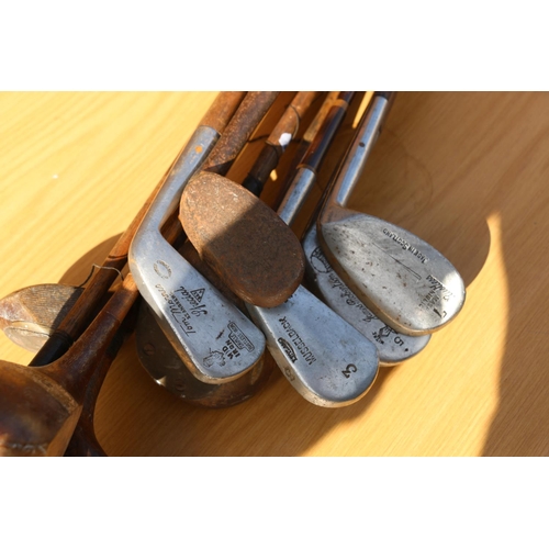 45 - Golf clubs to include eight hickory shafted clubs and two others, within pencil golf bag.