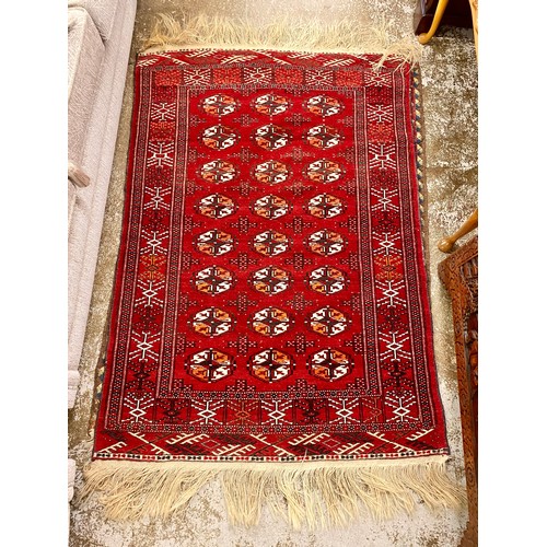 636 - Red ground wool rug 108cm x 155cm