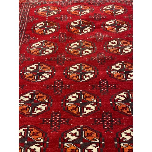 636 - Red ground wool rug 108cm x 155cm