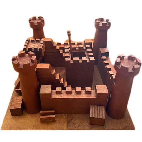 124 - Wooden castle building set within mahogany blanket box.