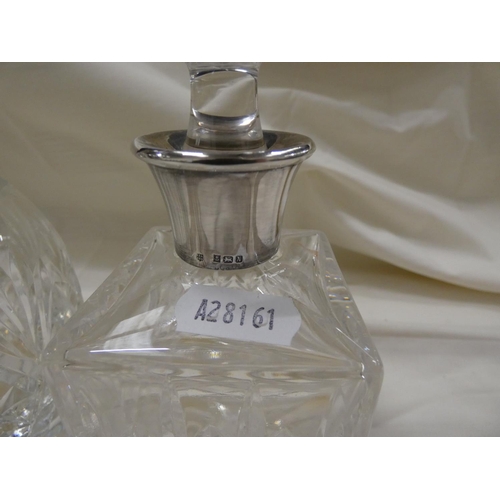 204 - Two cut glass perfume bottles with silver collars.