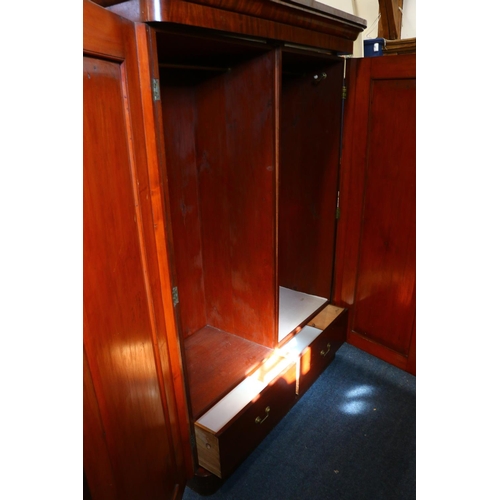 773 - Victorian mahogany two door wardrobe, with two interior base drawers, raised on plinth base, 207cm h... 