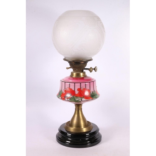 81 - Oil lamp with a poppy painted reservoir, 50cm.