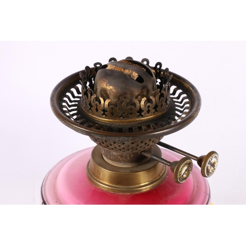 81 - Oil lamp with a poppy painted reservoir, 50cm.