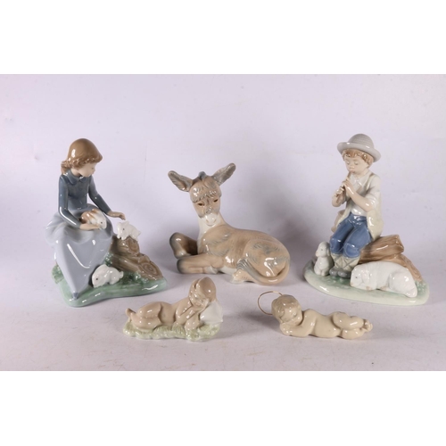 87 - Two Nao figures of children with animals, two Lladro Baby Jesus figurines, and a Zaphir donkey.