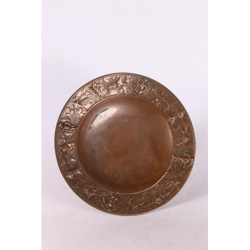 94 - Late 19th early 20th century copper tazza with foliate and cherub decoration to edge, 7 x 20cm.