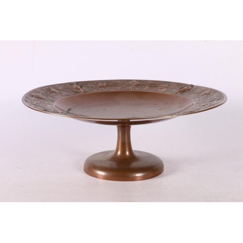 94 - Late 19th early 20th century copper tazza with foliate and cherub decoration to edge, 7 x 20cm.