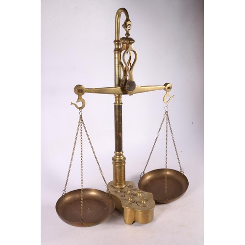 372 - Pair of brass balance scales, the weights nestled in the base, previously from an apothecary shop.