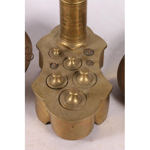 372 - Pair of brass balance scales, the weights nestled in the base, previously from an apothecary shop.