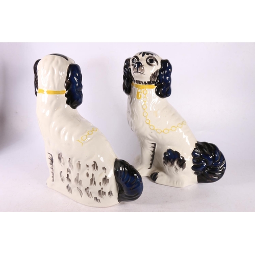 130 - Pair of Staffordshire spaniel dogs, and a Majolica ewer, 40cm.