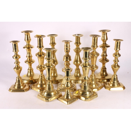 132 - Group of twelve brass candlesticks, largest 25cm. 