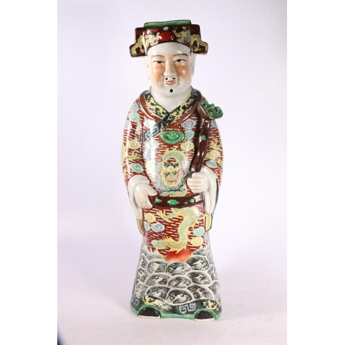 328 - Chinese pottery figure of a gentleman wearing a dragon decorated robe and holding a staff.