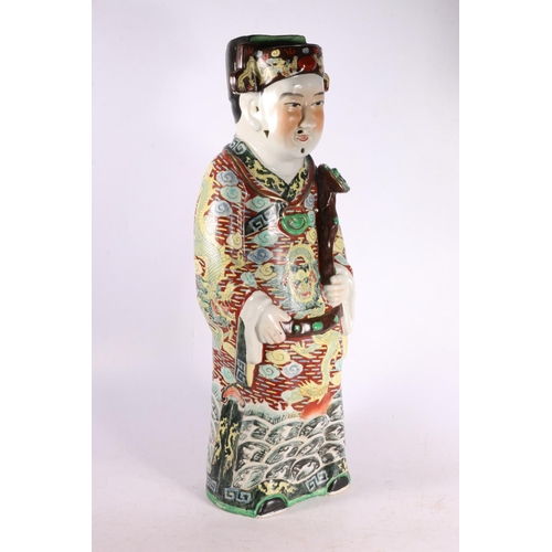 328 - Chinese pottery figure of a gentleman wearing a dragon decorated robe and holding a staff.