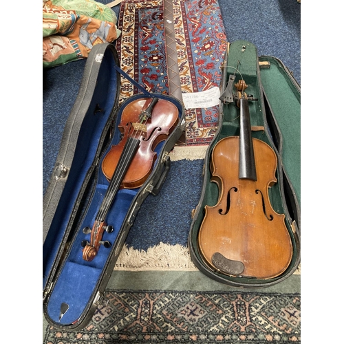 217 - Two violins of different sizes in cases. 