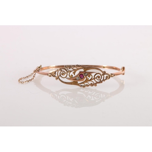 557 - Victorian 9ct gold bangle set with rubies and diamonds, makers D&C, 7.7g gross.