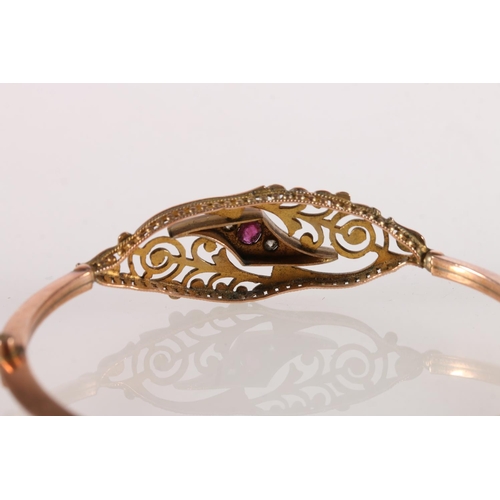 557 - Victorian 9ct gold bangle set with rubies and diamonds, makers D&C, 7.7g gross.