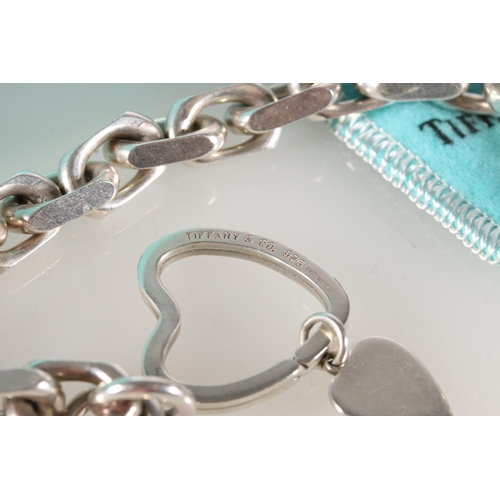 597 - Silver chain link bracelet, hallmarked Tiffany and Co., London 2001, with abstract heart shaped key ... 