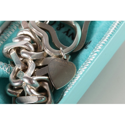 597 - Silver chain link bracelet, hallmarked Tiffany and Co., London 2001, with abstract heart shaped key ... 