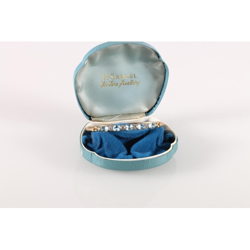 610 - 9ct gold hinged bangle with aquamarine stones spaced by clear stones, 7cm diameter, 7.2g. 