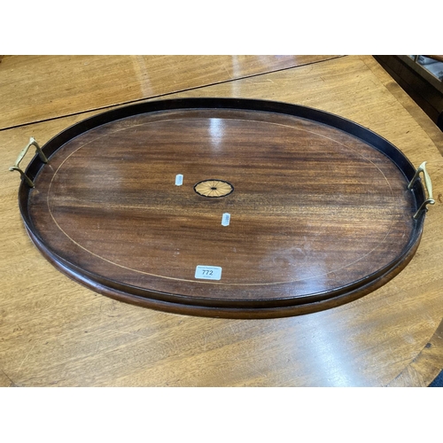 772 - Edwardian mahogany oval tray with raised handles, 69 x 45cm.