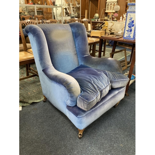 791 - Early 20th century wing back low chair on castors marked Homa Cosby Leicester, 93cm.