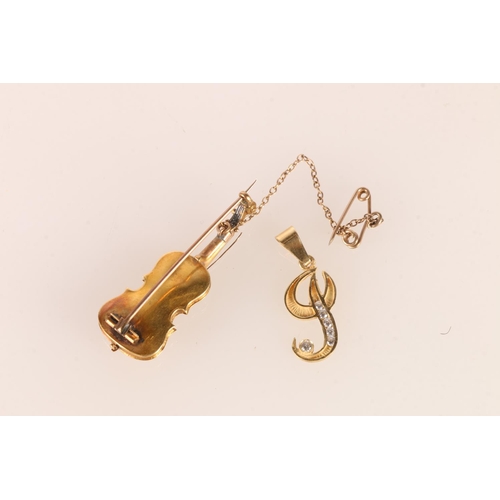 562 - 18ct gold ‘J’ pendant set with white stones, 0.9g, and a yellow metal violin brooch set ... 