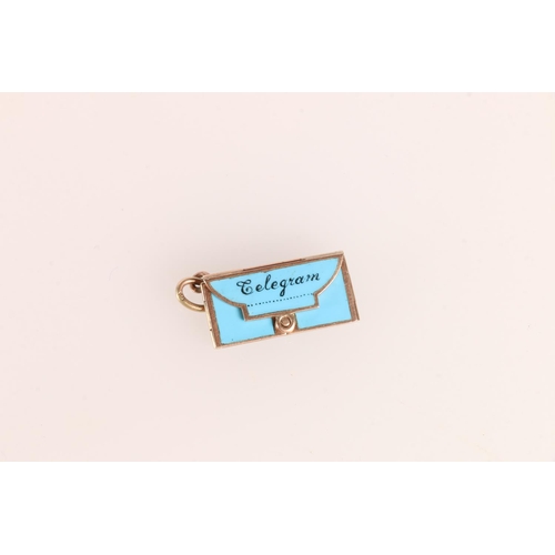 667 - 9ct gold and enamel bracelet charm in the form of a telegram envelope with message to the interior '... 