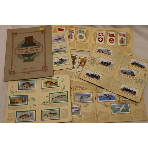 735 - Collection of cigarette cards held within 8 booklets including Military Uniforms, British Fresh-Wate... 