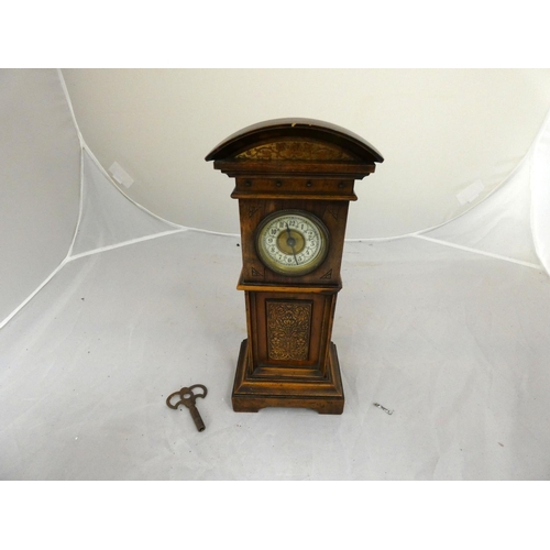 278 - Antique mahogany mantel clock in the form of a long case clock with enamel dial.