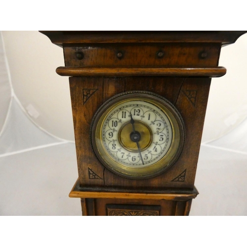 278 - Antique mahogany mantel clock in the form of a long case clock with enamel dial.