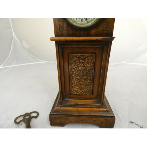 278 - Antique mahogany mantel clock in the form of a long case clock with enamel dial.