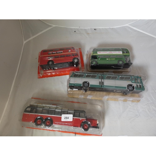 284 - Four large die cast coaches to include Mercedes, general motors.