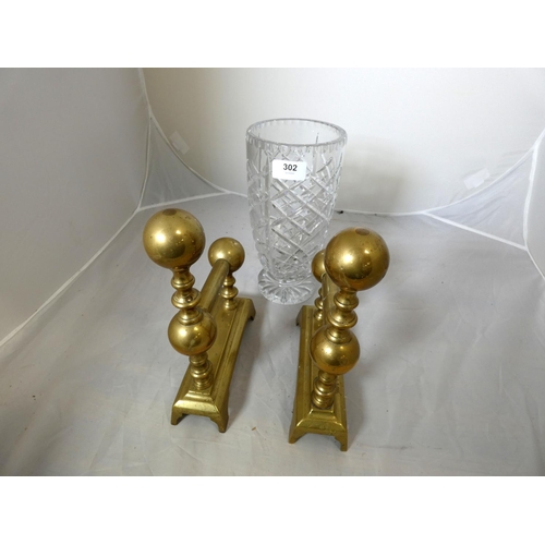 302 - Pair of brass fire dogs and large crystal glass vase.