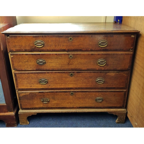 523 - George III oak chest of four long drawers on bracket feet.