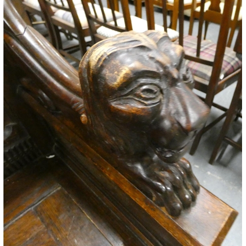 464 - Vintage oak monks bench with ornate carved lions for arms.