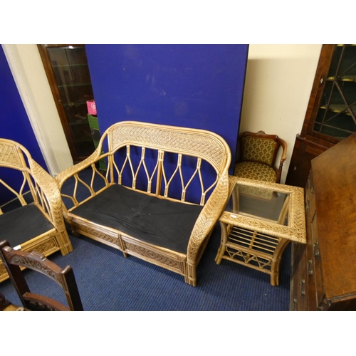 517 - Large cane conservatory suite comprising two seater sofa, chair and table.