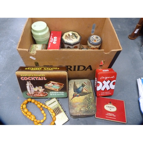 38 - Carton containing a collection of vintage tins, 1950s Thermos flask, amber-style beads etc.