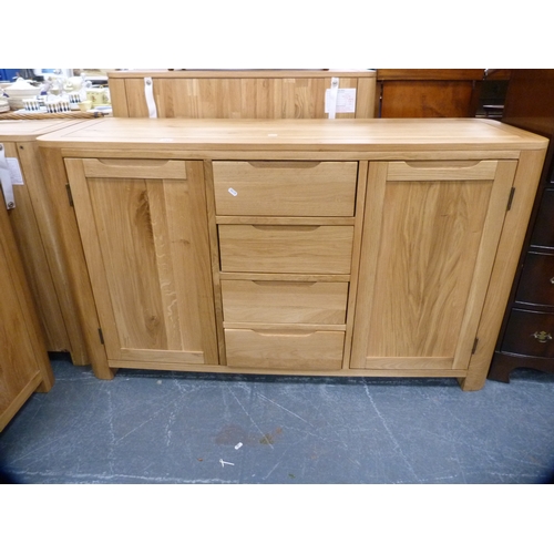 449 - Contemporary oak cabinet fitted with four central drawers flanked by cupboards.