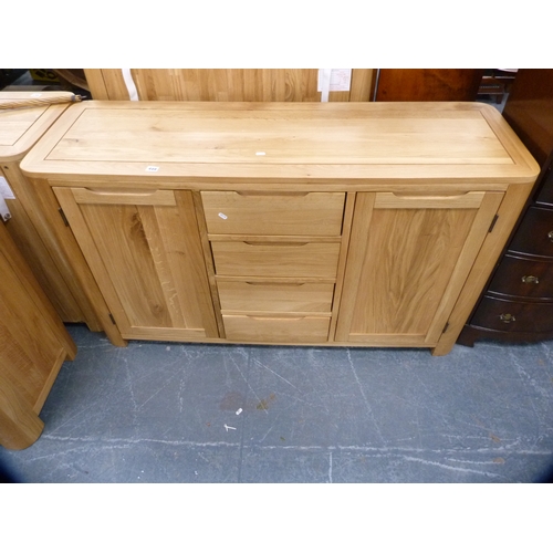 449 - Contemporary oak cabinet fitted with four central drawers flanked by cupboards.