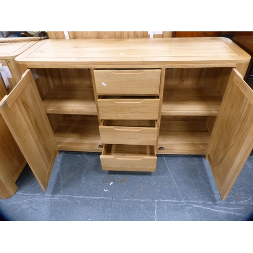 449 - Contemporary oak cabinet fitted with four central drawers flanked by cupboards.