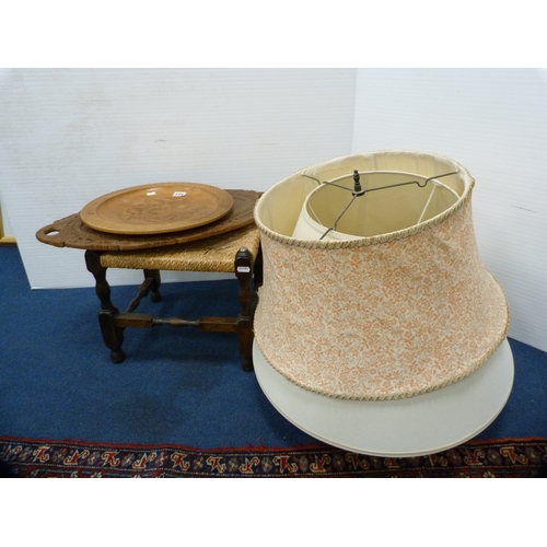 523 - Oak-framed stool, two wooden trays and a quantity of lampshades.