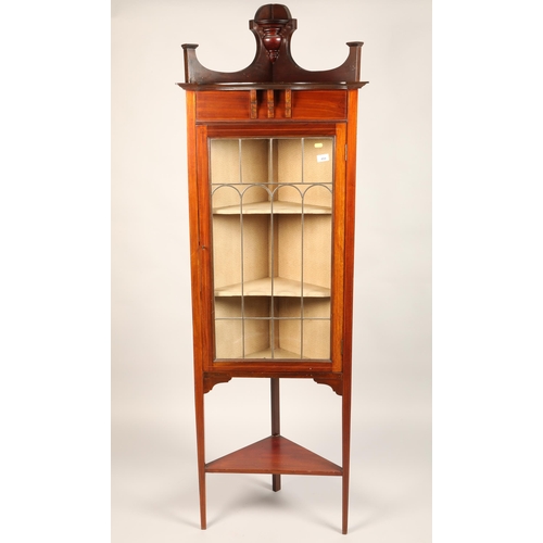 494 - An Edwardian inlaid mahogany corner display cabinet enclosed by astragal glazed door