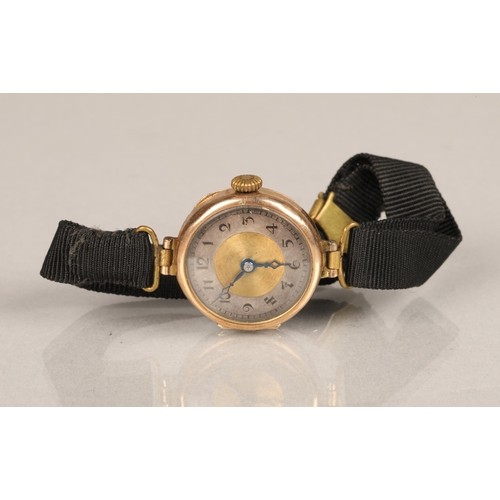 141 - Ladies 9 ct gold wrist watch with material strap