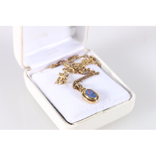 557 - 18ct gold mounted opal pendant, on gilt metal chain.