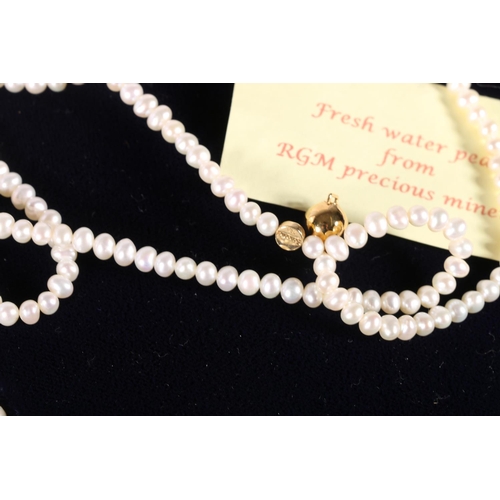 582 - Two boxes containing faux pearl necklaces.