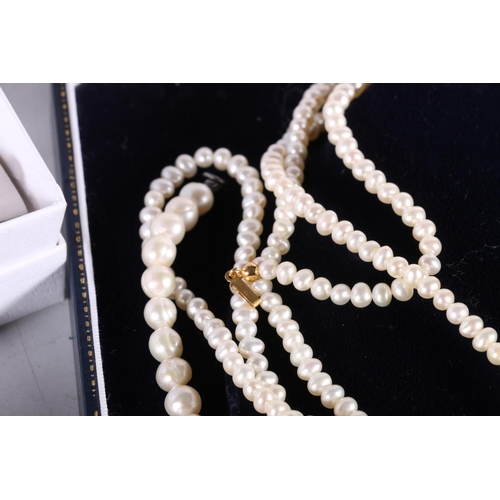 582 - Two boxes containing faux pearl necklaces.